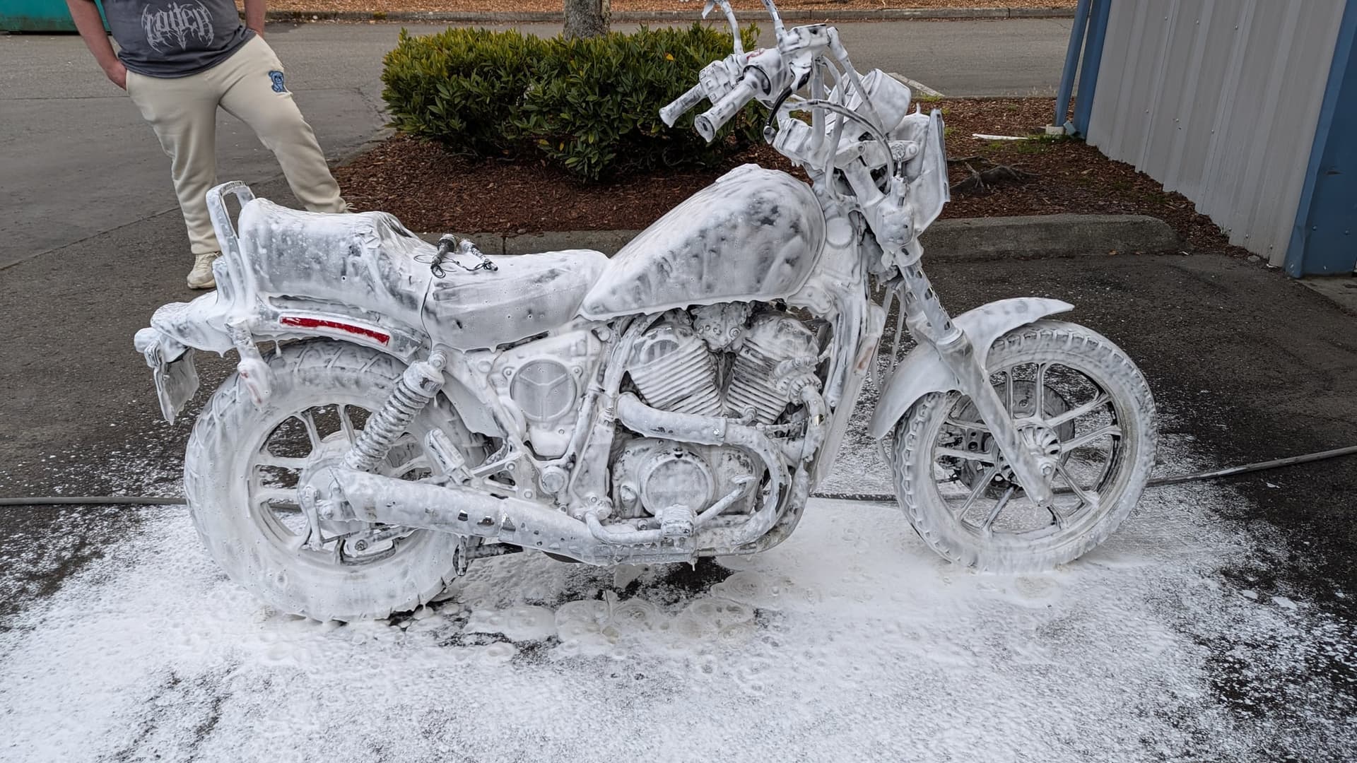 Motorcycle during a wash with foam on it
